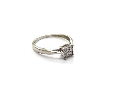 A white gold ring, marks rubbed set with nine small diamonds in square settings. Size J/K, 1.1g 