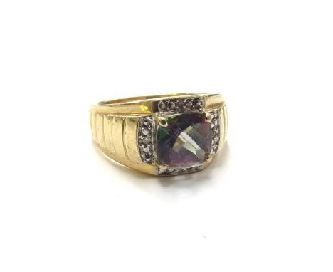 A gents gold ring set with a facet cut mystic topaz framed by diamonds, stamped 10k. Size V, 6.5g 