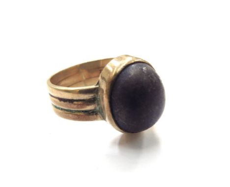 A gold ring stamped 9ct with an oval cabochon Lapis Lazuli, worn. Size T/U, 8g 