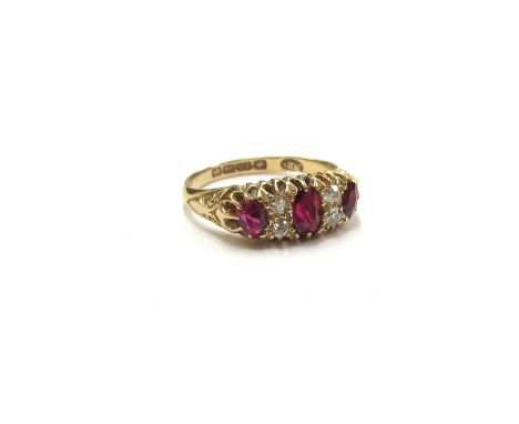 An 18ct gold ruby and diamond seven stone ring, Birmingham 1904. Size L, 3.2g 
