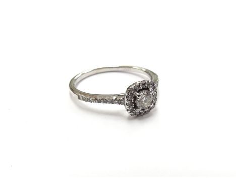 An 18ct white gold diamond cluster ring with diamond set shoulders. Size K, 2.1g 