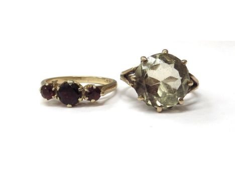 A 9ct gold citrine ring, size L and a gold three stone garnet ring stamped 9k, size M, 6.2g 