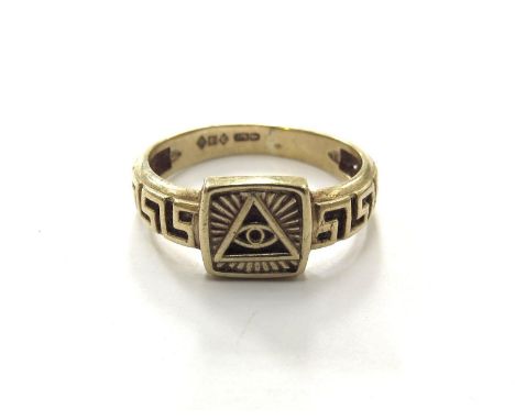 A 9ct gold ring with the magic eye symbol, Greek key patterned band. Size Q, 3.1g 