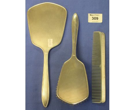 Three piece silver lady's vanity set comprising: mirror; brush and comb, Birmingham hallmarks. (3)(B.P. 24% incl. VAT)