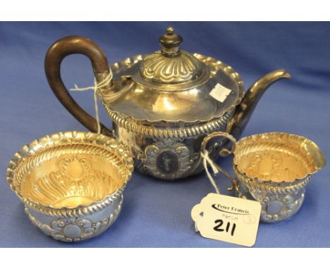 Late Victorian silver three piece bachelor's tea set comprising: teapot; sugar bowl and cream jug, overall with repousse flut