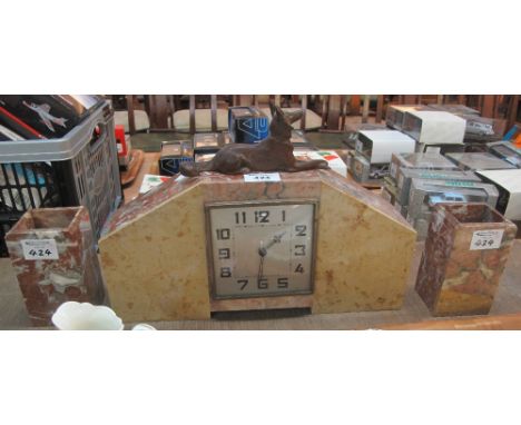 Art Deco design marble clock with spelter recumbent Alsatian dog together with matching garnitures. (3) (B.P. 24% incl. VAT)