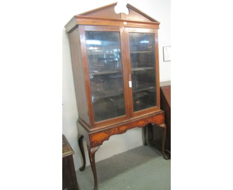 Late 18th/early 19th Century Dutch marquetry cabinet upon stand, having broken swan neck pediment above two glazed doors, rev