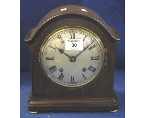 Early 20th Century mahogany arch topped mantel clock, having silvered Roman face and two train movement striking on one gong.