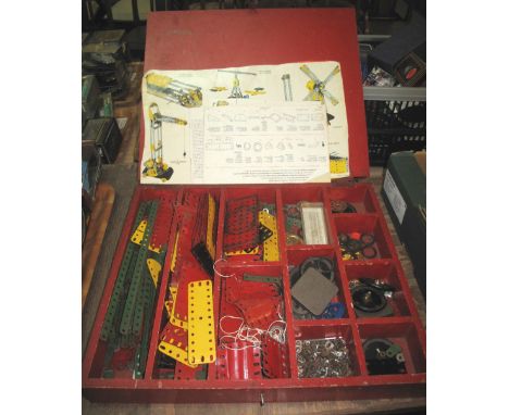 Painted wooded Meccano box containing assorted Meccano pieces: cogs; bolts; nuts etc., instruction manual.(B.P. 24% incl. VAT