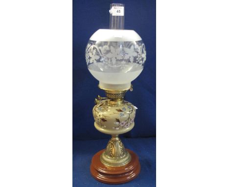 Early 20th Century brass double burner oil lamp with painted glass reservoir on repousse brass pedestal with ceramic base, et