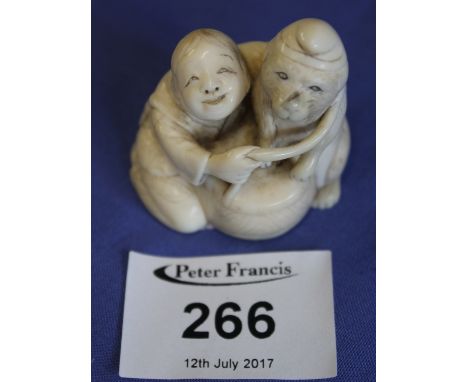 Early 20th Century Japanese ivory Netsuke of a child and dog, signed to base.(B.P. 24% incl. VAT) 