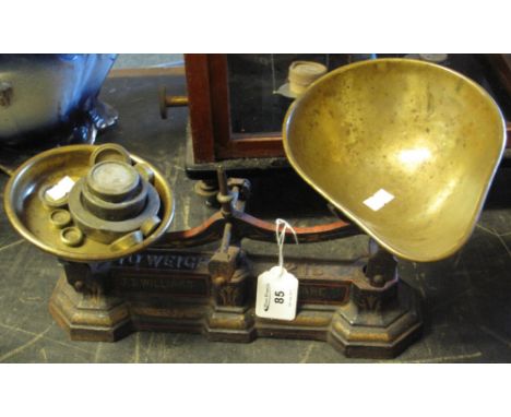 Small set of cast iron shop scales with copper pans and brass weights, marked: J.D. Williams, Aberdare.(B.P. 24% incl. VAT)