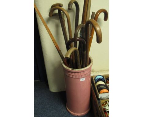 Ceramic stick stand with an assortment of wooden walking sticks, to include one with carved pig handle, and a bundle of five 