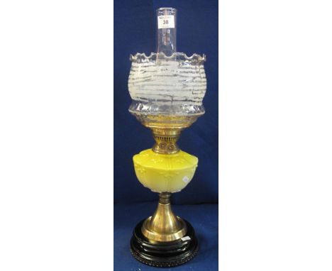 Early 20th Century brass double burner oil lamp with ceramic reservoir on brass pedestal with ceramic base, fluted glass shad