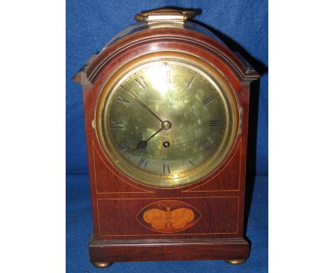 Edwardian inlaid mahogany arch topped bracket or mantel clock, having brass Roman face marked: Barraud and Lunds of London. (