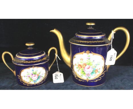 Limoges Porcelain teapot and sucrier, having hand painted reserved panels of flowers on a cobalt blue ground with gilt handle