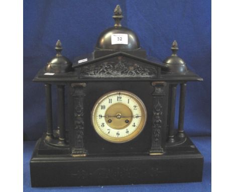 Late Victorian black slate architectural mantel clock with three domed finials above ancient battle frieze, enamel face with 