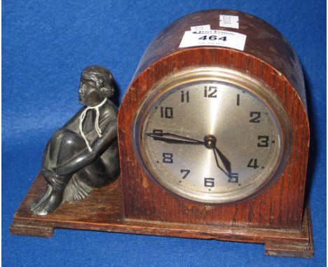 Early 20th Century oak mantel clock with bronzed seated female figure and silvered face.(B.P. 24% incl. VAT)