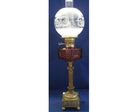 Early 20th Century converted brass oil lamp with red glass reservoir and brass Corinthian column base decorated with Classica