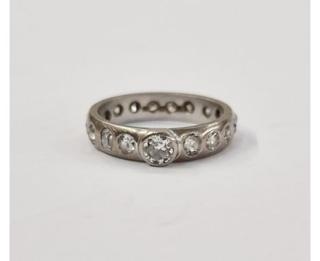 Platinum and diamond ring, set central raised stone, 0.2-0.25 approx, the band set all around with multiple diamonds. Size I