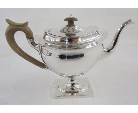 Early 20th century footed oval teapot and hinged cover, with turned wood handle and knop finial, the front cast with a maiden