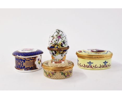 Collection of porcelain and enamel snuff and pill boxes, including an egg-shaped Limoges-style box and cover on gilt tripod l