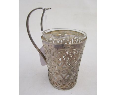 1920s silver mounted flask /jug, the scroll handle with spoon support, the body scroll pierced, with glass liner 14cm h., Bir