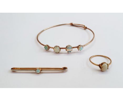 Gold-coloured and four-stone opal bangle set graduated oval opals, an opal bar brooch&nbsp;and an opal ring set single oval c