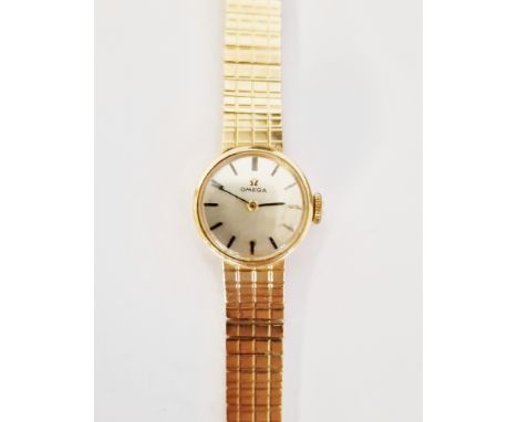 Vintage lady's 9ct gold Omega wristwatch, the circular silvered dial having baton hour markers, housed in 9ct gold case on 9c