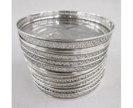 Set of ten 20th century American sterling silver and glass mounted coasters, each with pierced circular pattern gallery above