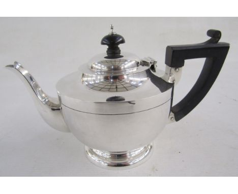 George V silver part tea-service, comprising: a teapot with hinged cover, turned wood handle and finial, a footed circular cr