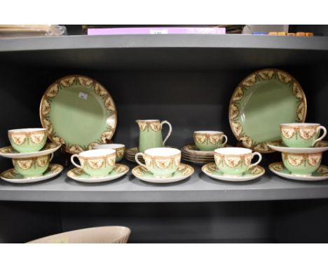 A collection of circa 1912 Royal Worcester table ware, having green and cream ground with brown swag and foliate transfer pat