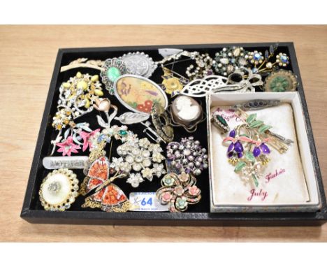 A collection of costume brooches of various designs including paste set Edwardian style bar brooches, a Celtic style knot and