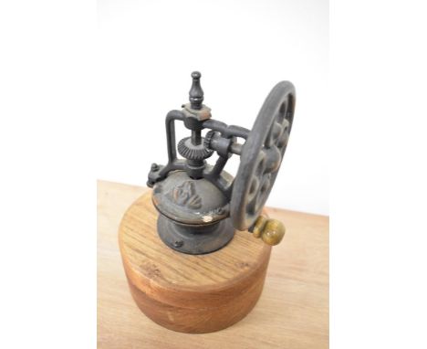 A vintage wooden manual coffee grinder, measuring 25cm tall