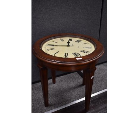 A vintage stained wood coffee table, having an integral working clock within, measuring 55cm tall