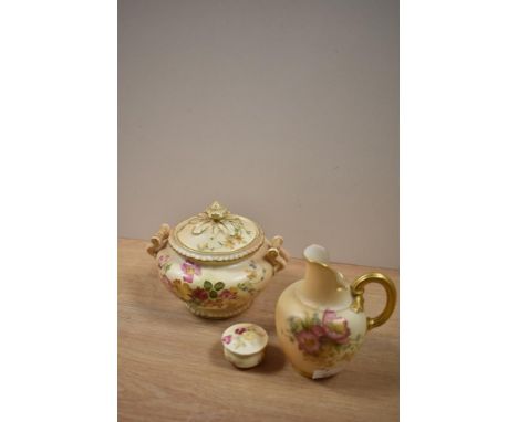 An early 20th Century Royal Worcester blush ivory lidded jar, measuring 12cm tall, together with a jug, and lidded trinket po