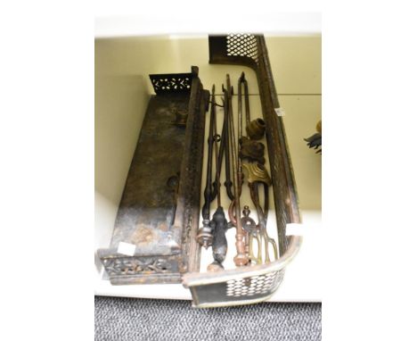 A collection of vintage fireside tools and two hearth guards.