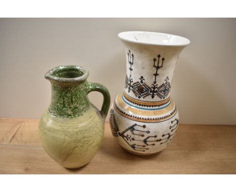 A 20th Century hand painted Greek design vase, measuring 29cm tall, and a glazed earthenware two tone pitcher