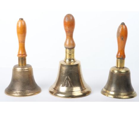 2x ARP Brass Handheld Bells, with turned wooden handles. Engraved ARP to the lower edge. Accompanied by a larger brass handhe