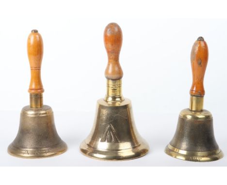 2x ARP Brass Handheld Bells, with turned wooden handles. Engraved ARP to the lower edge. Accompanied by a larger brass handhe