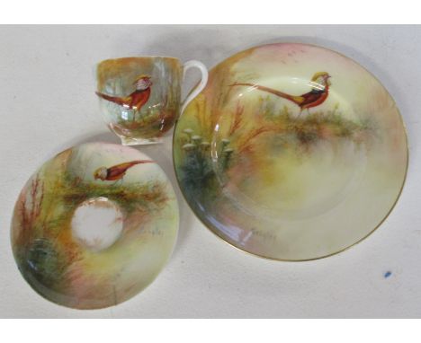 A Royal Worcester trio, all three pieces decorated with a golden pheasant in foliage by Sedgley