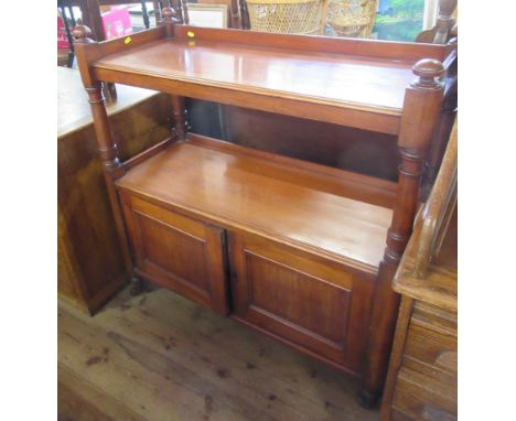 A 19th century mahogany buffet, with two shelves over a cupboard with turned supports, width 40ins, depth 16ins, height 43ins