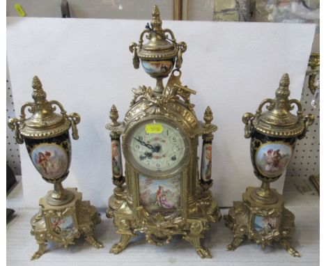 A 20th century reproduction brass and porcelain clock garniture, height of clock 17ins