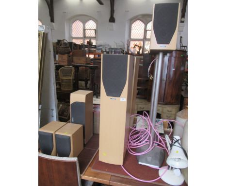 A collection of Mission speakers, some with stands and an angle poise lamp