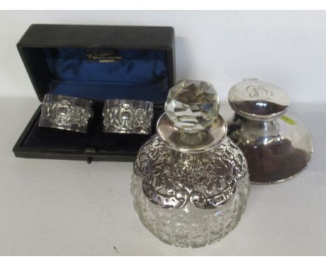 An Asprey &amp; Co silver capstan inkwell, engraved with initials and date, together with a cased pair of silver napkin rings
