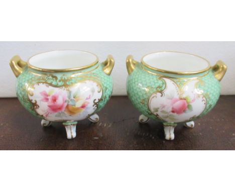 A pair of Grainger &amp; Co Worcester vases, decorated with reserves of flowers to a scale green ground, shape number 160, he