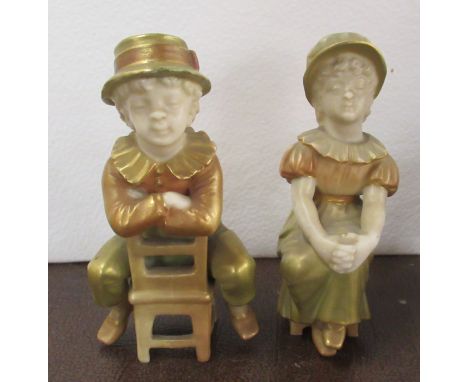 A pair of Royal Worcester shot silk Kate Greenaway figures, seated childrenCondition Report:  The back leg of the boys chair 