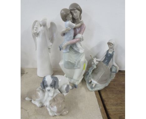 Two Lladro models, together with a Nao model of puppies and another white figure