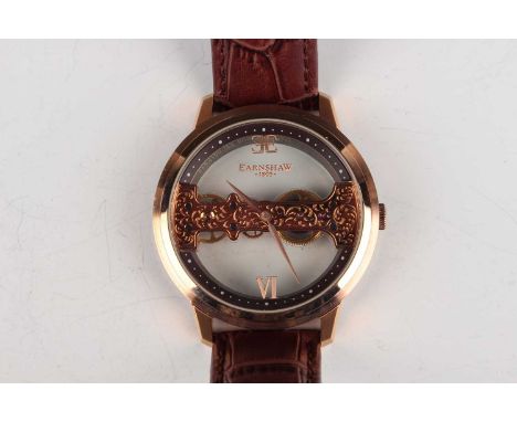 An Earnshaw gilt metal and stainless steel gentleman’s wristwatch, the glazed front and back displaying a skeletonized manual