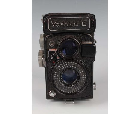 A Yashica-E twin lens reflex camera, No. YE 3100091, with Yashinon 1:3.5 lenses, leather cased.